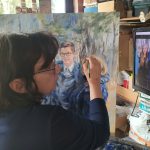 Marlien painting on a canvas